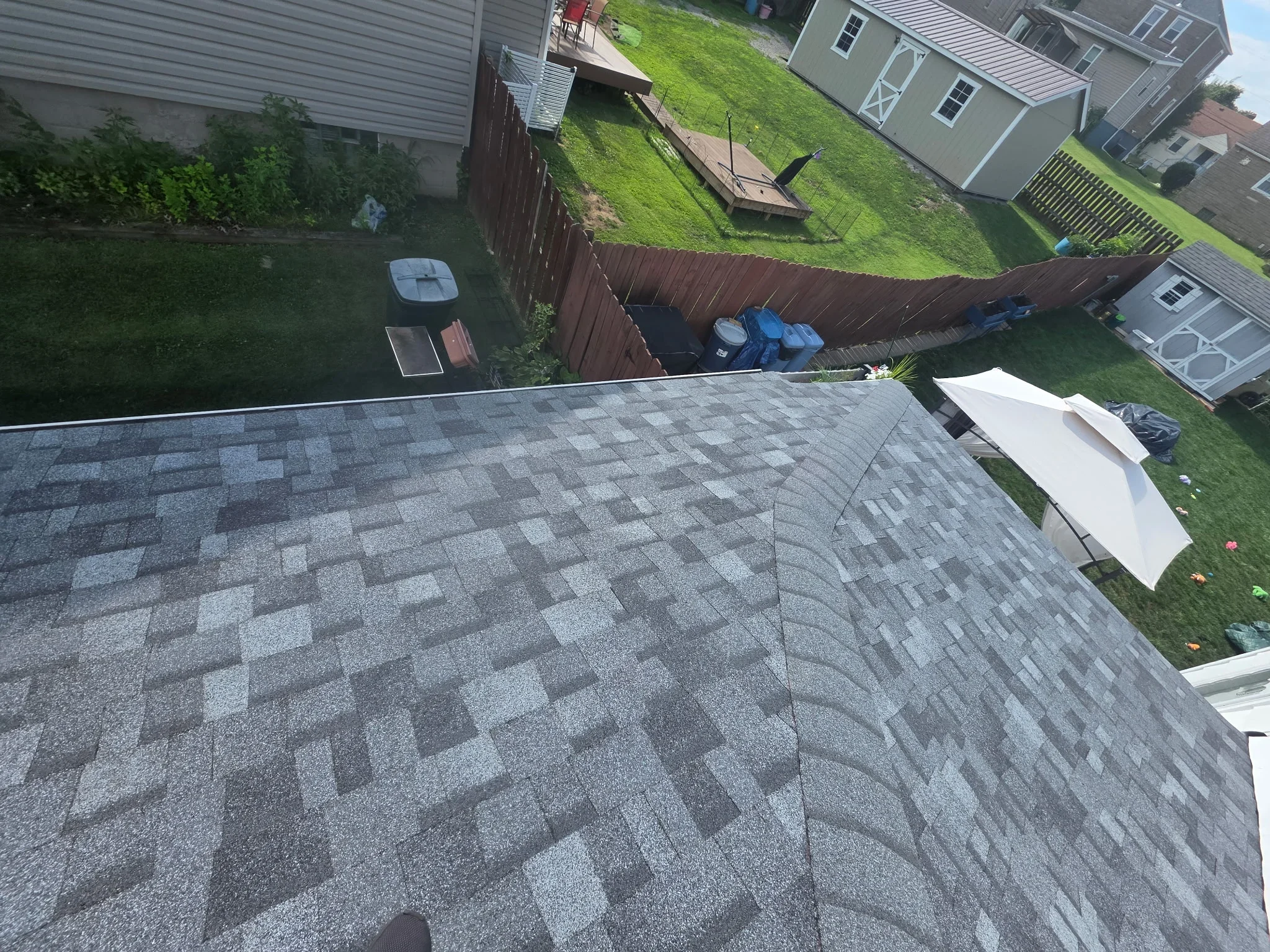 Gray architectural shingles with diamond pattern on residential roof installation