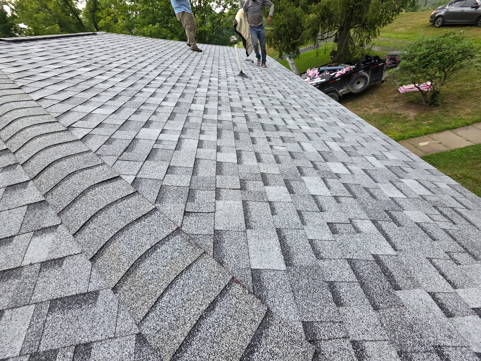 Gray architectural asphalt shingles installed in dimensional pattern on residential roof