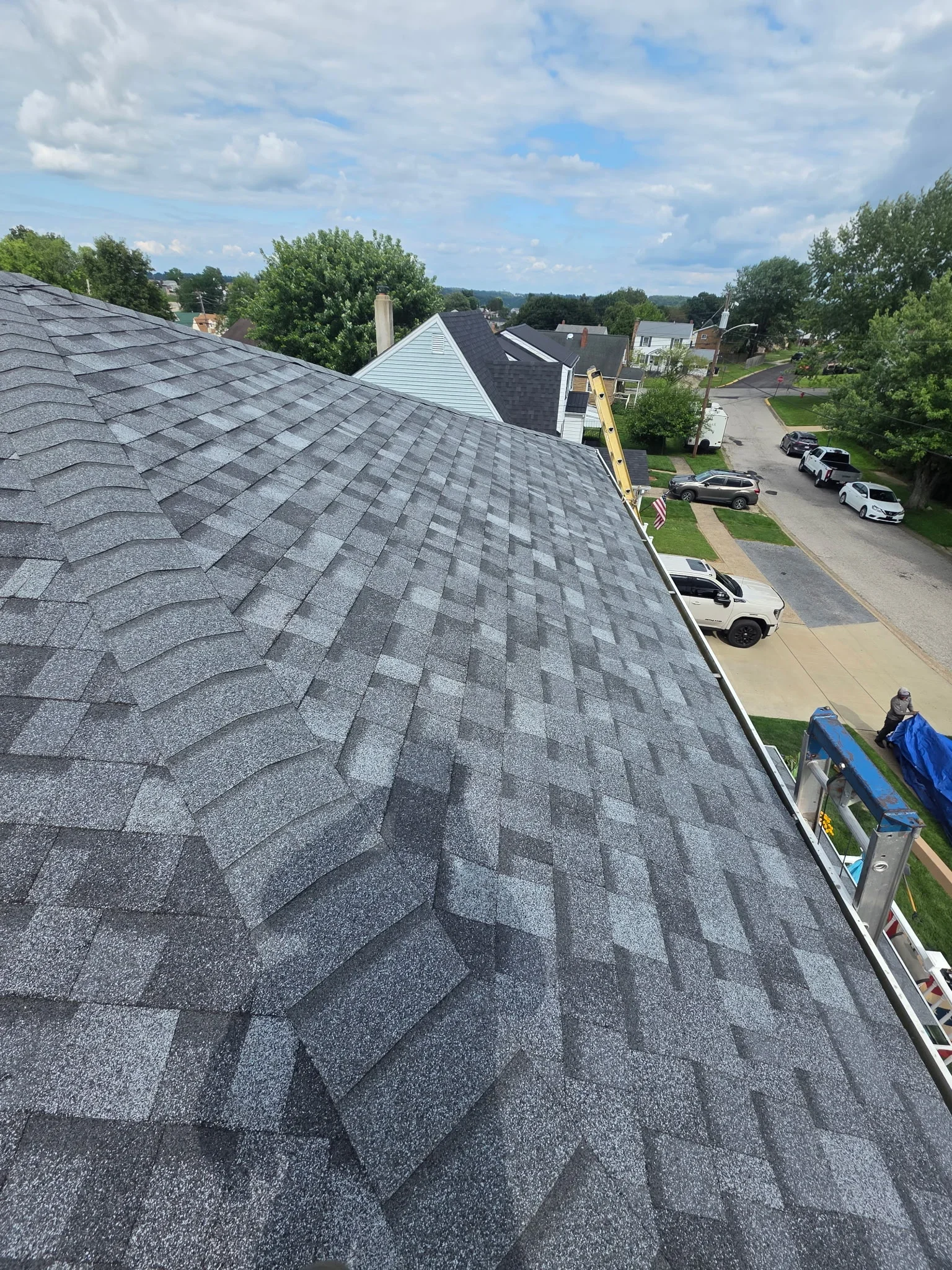 Gray architectural shingles installed on residential roof with dimensional pattern and clean edge lines
