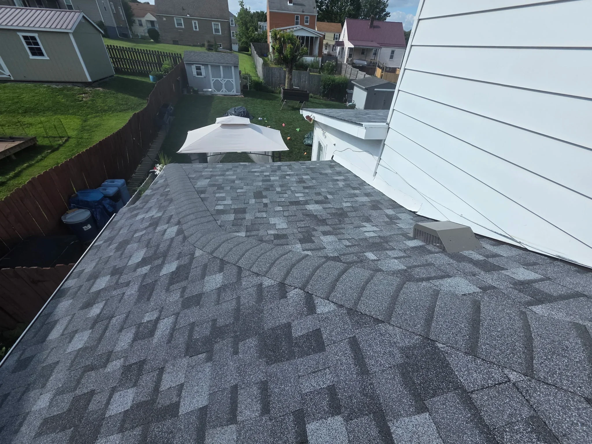 Charcoal gray architectural shingles installed in dimensional pattern on residential roof
