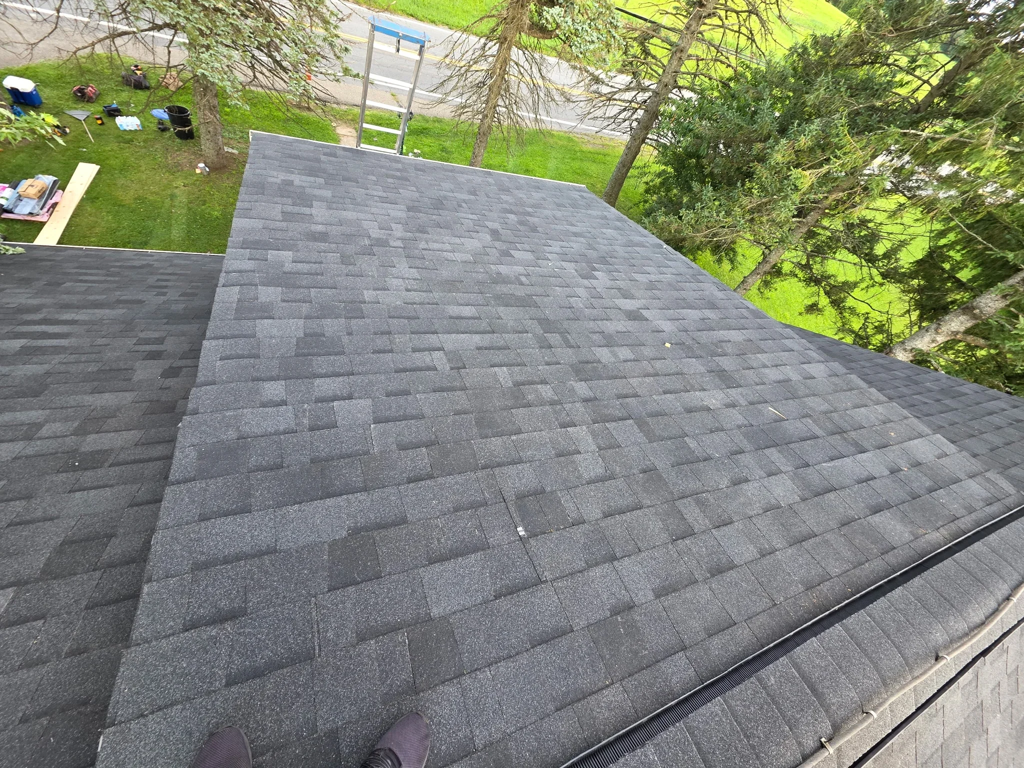 Charcoal gray architectural shingles installed in staggered pattern on residential roof