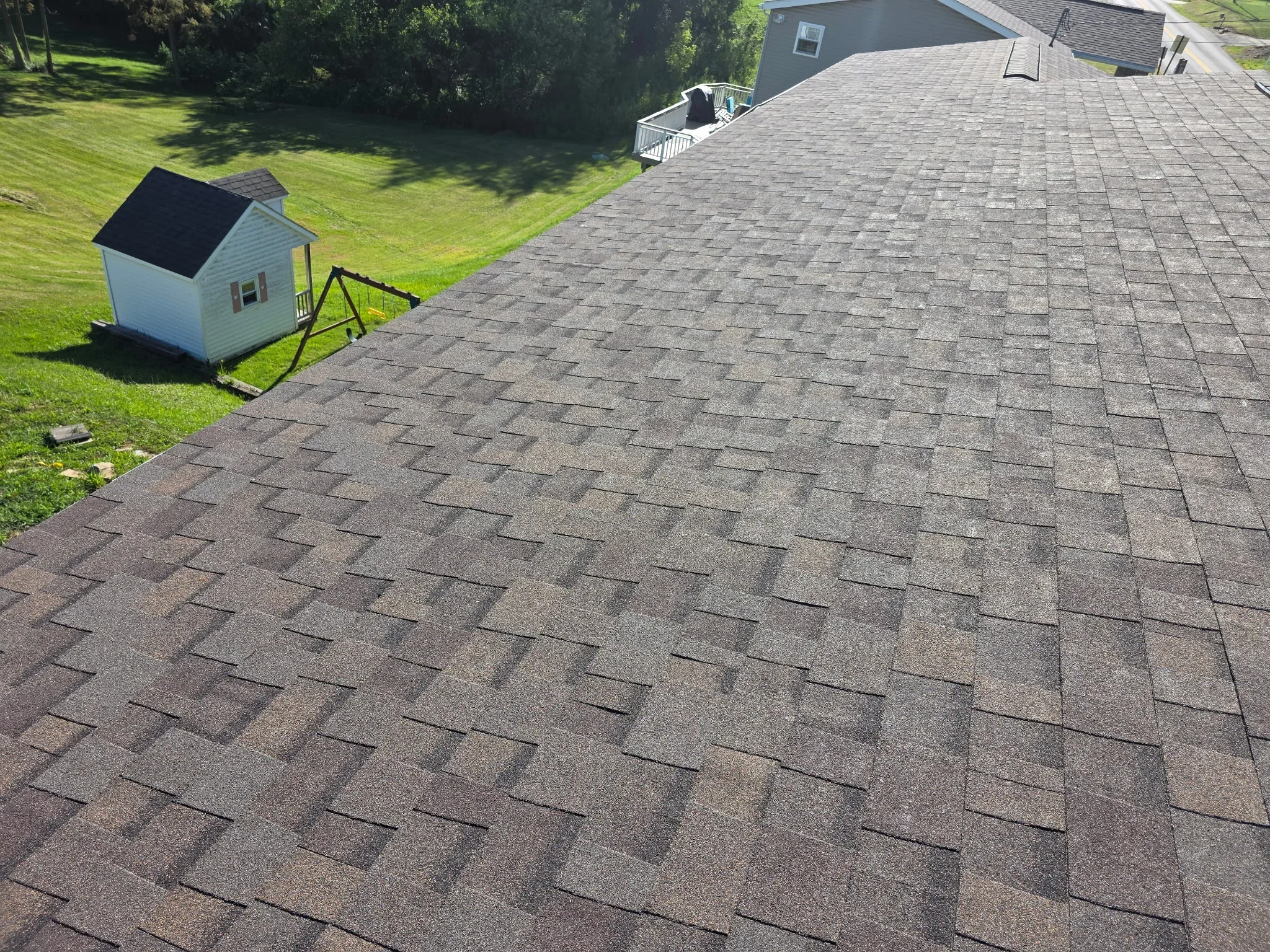 Charcoal gray architectural shingles installed in staggered pattern on residential roof